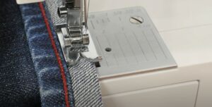 Sewing the hem of the jeans