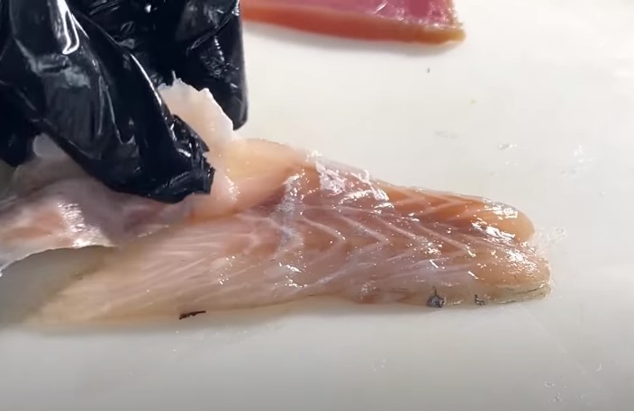slicing the fish for sushi